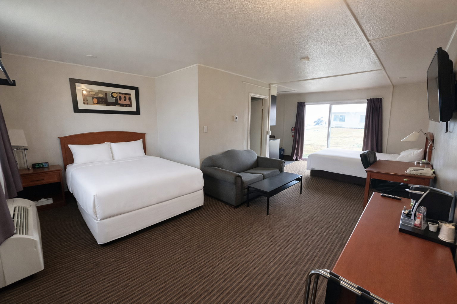 Guest room with two queen beds and kitchenette